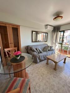 a living room with a couch and a table at Las Palmeras -Marbella Centro- by Completely Marbella in Marbella