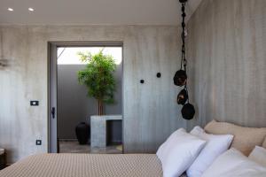 Postel nebo postele na pokoji v ubytování Kumo Villas