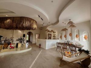 a large kitchen with a table and chairs in a room at Country Road Villa in Xuyên Mộc