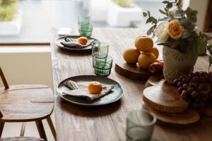 a wooden table with plates of food on it at Country Road Villa in Xuyên Mộc +16 photos