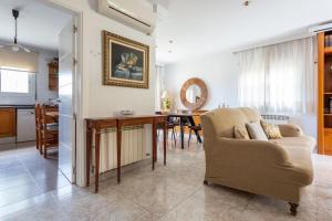 sala de estar con sofá y comedor en Preciosa casa cerca de la playa, en Castelldefels