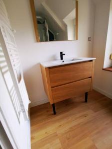 a bathroom with a sink and a mirror at Maison au coeur de ville parking in Paimpol +10 photos
