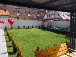 a garden with red hearts balloons and a hammock at Twins in Tbilisi City