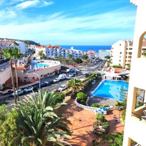a view of the city and the ocean from a building at Castle Harbour Duplex With Pool View C115 in Los Cristianos