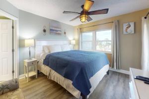 a bedroom with a bed and a ceiling fan at 306 - Gulf Strand in St. Pete Beach