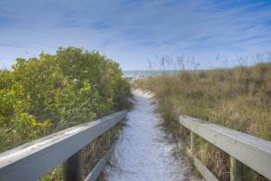a path through a field with a wooden bridge at 306 - Gulf Strand in St. Pete Beach