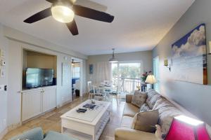 a living room with a couch and a ceiling fan at 306 - Gulf Strand in St. Pete Beach