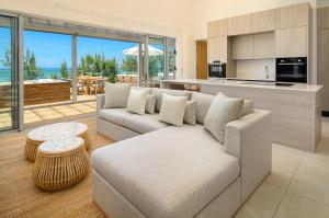 a living room with a couch and a table at Ocean Grand Gaube by 2futures Holidays in Grand Gaube