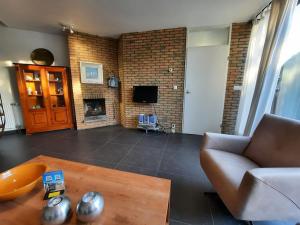 a living room with a couch and a fireplace at Zouterik 33* in Nieuwvliet