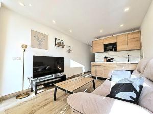 a living room with a couch and a table at Un pisito en Maspalomas in Maspalomas