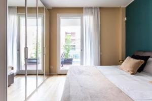 a bedroom with a large bed and a large window at Luxury Flat Giardini D'Inverno in Milan