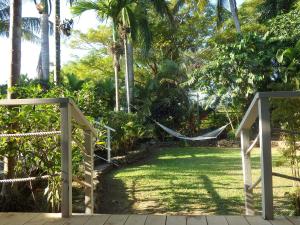 a hammock in a garden with palm trees at Bluewater Lodge in Nadi