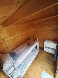 a room with a bed in a wooden attic at Agriturismo Fattoria Ca Di Sole in San Benedetto Val di Sambro