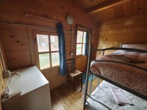 a bedroom with two bunk beds in a log cabin at Agriturismo Fattoria Ca Di Sole in San Benedetto Val di Sambro