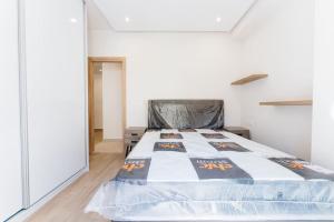 a bedroom with a bed with a comforter on it at Comfy Apartment Near Acropolis in Athens