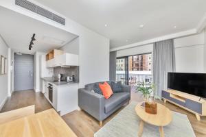 a living room with a couch and a table at The Barracks Apartments in Cape Town +38 photos