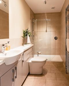 a bathroom with a sink and a toilet and a shower at Sea Sound in Cellardyke