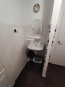 a bathroom with a sink and a mirror and a toilet at Płonia Economy in Szczecin
