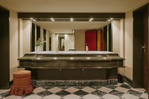 a bathroom with a large mirror and a sink at Locke am Platz Zurich in Zurich