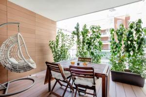 a dining room with a table and chairs and plants at Luxury Flat Giardini D'Inverno in Milan