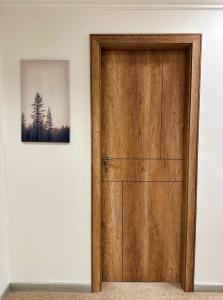 a wooden door in a room with a picture at The Arabella House - Madinaty in Madinaty