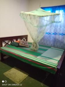 En eller flere senge i et værelse på Sigiriya Homestay