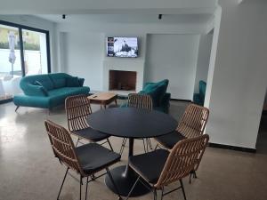 a room with a table and chairs and a couch at Evita Blue in Xylokastro