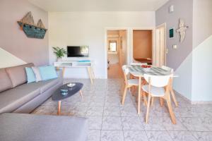 a living room with a couch and a table at Catherine Blue Suites - 4 minutes off the Beach in Póros Kefalonias