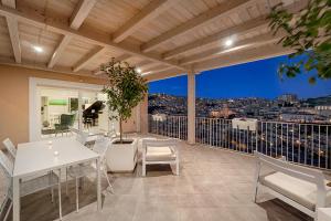 a balcony with a table and chairs and a view at Itria Modica in Modica