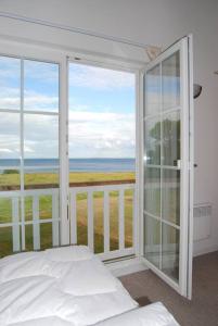 a bedroom with a bed and a view of the ocean at Ferienhaus Meerblick in Sierksdorf