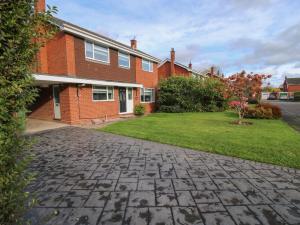 a brick house with a green lawn in front of it at Field View in Newport