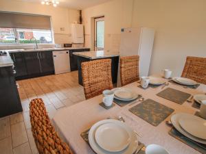 a kitchen with a table with plates on it at Field View in Newport