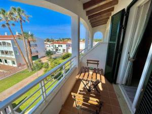 a balcony with a bench and a view of the ocean at Mitjaneta Apartamento con piscina in Cala en Blanes