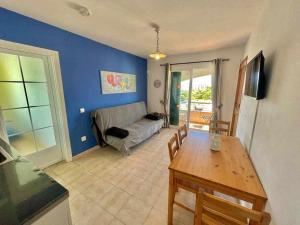 a living room with a couch and a table at Mitjaneta - Apartamento con piscina in Cala en Blanes
