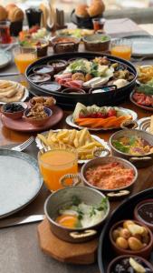 a table with many different types of food on it at Azure Cave Suites - Cappadocia in Goreme