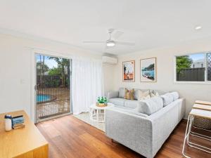a living room with a couch and a table at Southport Oasis 6BR Pool Central in Gold Coast