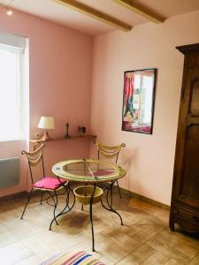 a dining room with a glass table and two chairs at Maisonnette studio centre de St JeanPied de port in Saint-Jean-Pied-de-Port