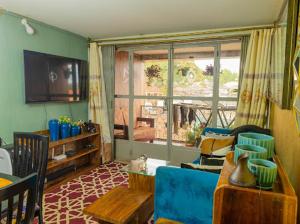 a living room with a blue couch and a window at Luzira Plaza in Kampala