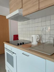 a kitchen with a counter top with white appliances at Sara's apartment Barcelona in El Prat de Llobregat