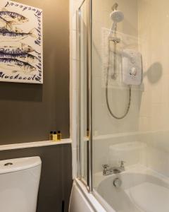 a bathroom with a shower and a toilet and a sink at Sea Breeze in Anstruther