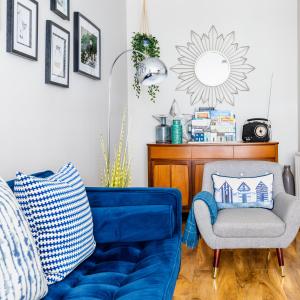 a living room with a blue couch and a chair at Sea Breeze in Anstruther