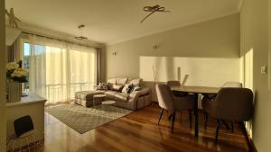 a living room with a table and a couch at Infinity pool & Amazing Sunset Ocean View in Funchal