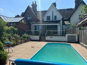 a swimming pool in front of a house at 7 The Village in Ilkeston