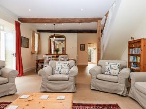 a living room with two chairs and a table at Dishcombe Cottage in Okehampton