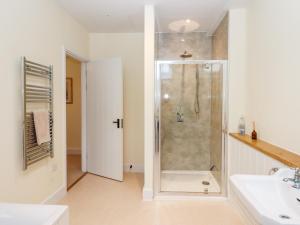 a bathroom with a shower and a sink at Dishcombe Cottage in Okehampton +49 photos
