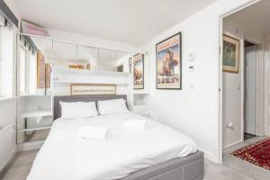 a white bedroom with a large white bed in it at Fort Avenue - No 31 Guardbridge in Guardbridge