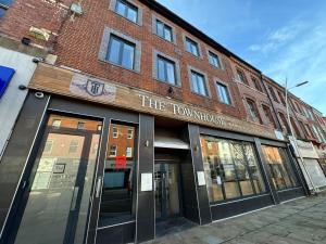 a red brick building with the townhous at The Townhouse Boutique Hotel in Barrow in Furness