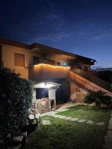 a house with lights on the side of it at night at Il villino in Santa Marinella