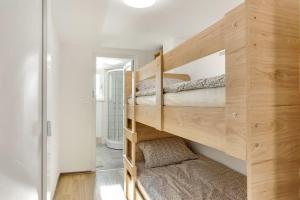 a bedroom with two bunk beds in a wooden room at Nature Cottage in Gabrce with sauna in Rogaška Slatina