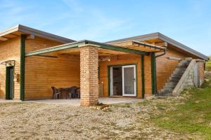 a wooden house with a porch and a patio at Nature Cottage in Gabrce in Rogaška Slatina